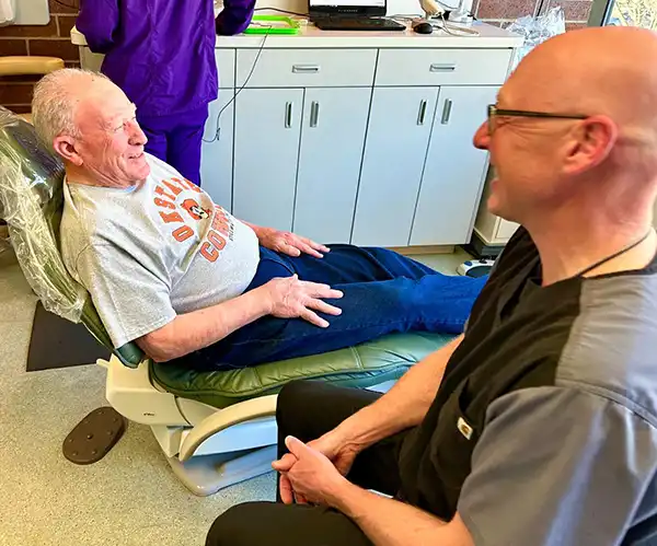 Meet your periodontist Barry and patient talking and smiling